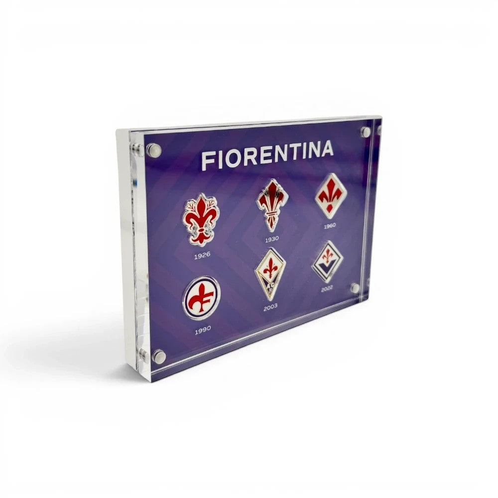 Am Ball Acrylrahmen mit historischen ACF Fiorentina Vereinslogos in verschiedenen Designs auf violettem Hintergrund