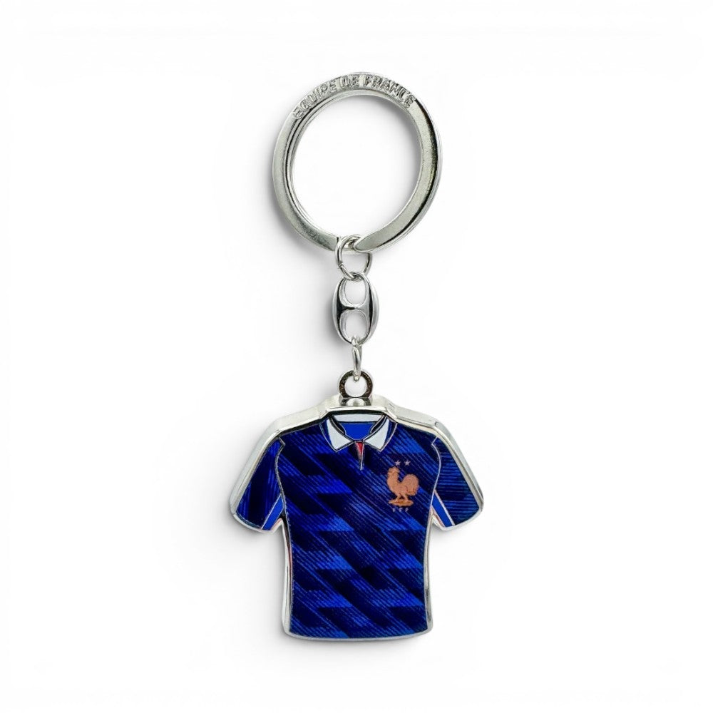 FFF Schlüsselanhänger in Form eines blauen Trikots mit "Equipe de France"-Schriftzug und Einkaufswagen-Jetons. Aus Zamak.