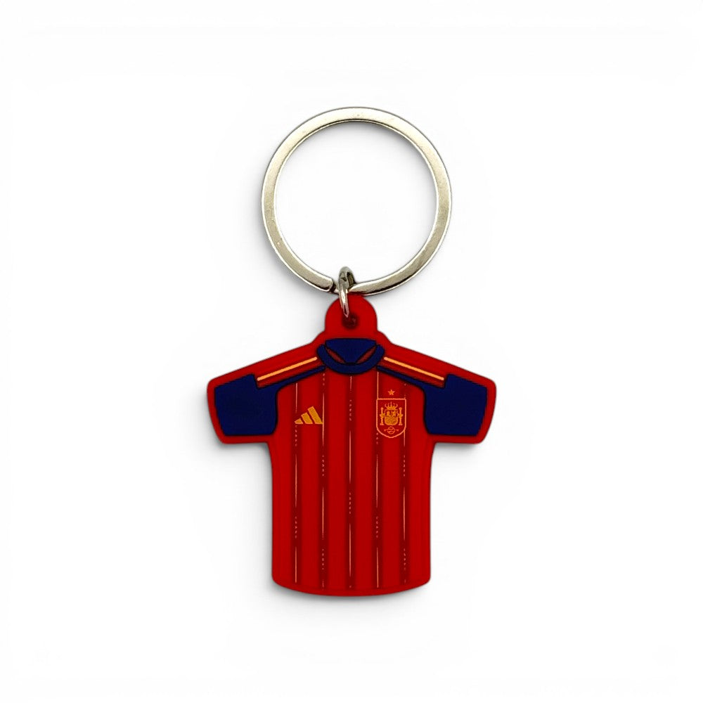 Keyring featuring the design of the Spain jersey (2026 World Cup), made from red PVC with dark blue accents.