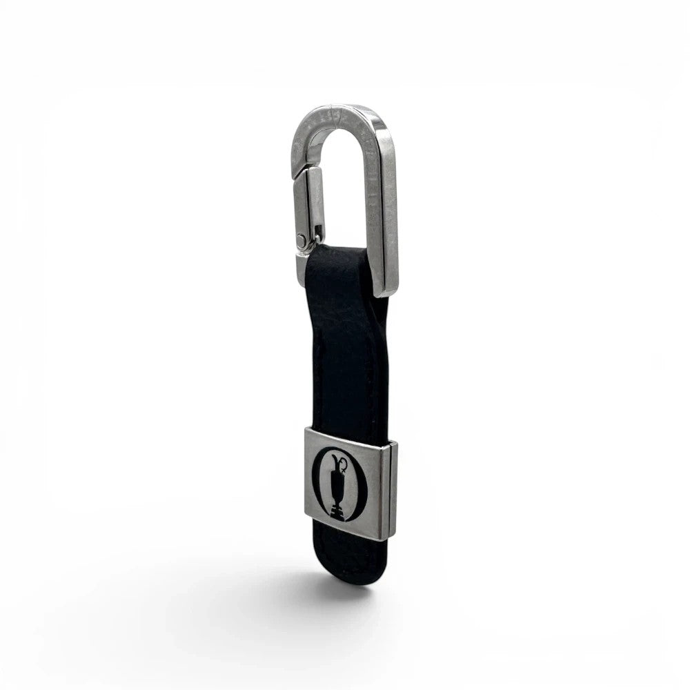 The Open Leder-Schlüsselanhänger in Schwarz mit silbernem Karabiner und Trophäen-Emblem