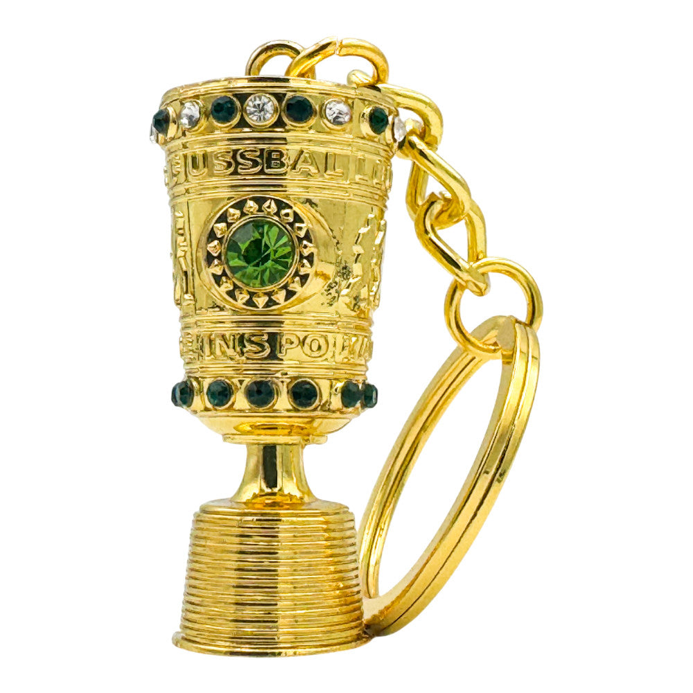 Close-up of the DFB Pokal mini trophy keyring showing the intricate engraving and golden finish.